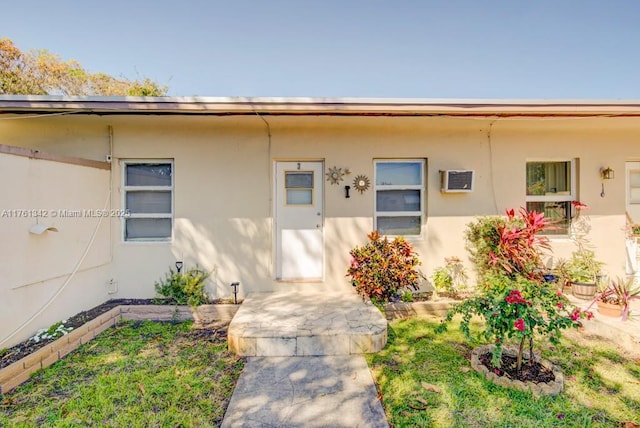 view of exterior entry featuring stucco siding