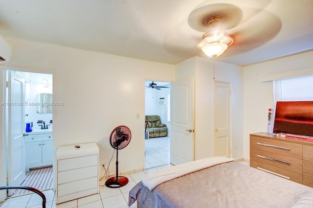 bedroom featuring connected bathroom, baseboards, light tile patterned flooring, and a ceiling fan