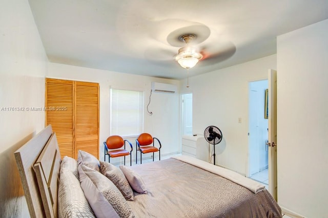 bedroom featuring a ceiling fan, a closet, and a wall mounted AC