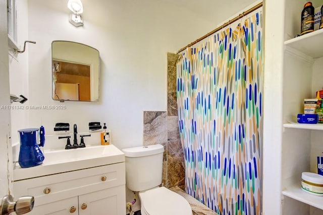 bathroom featuring a shower with curtain, toilet, and vanity