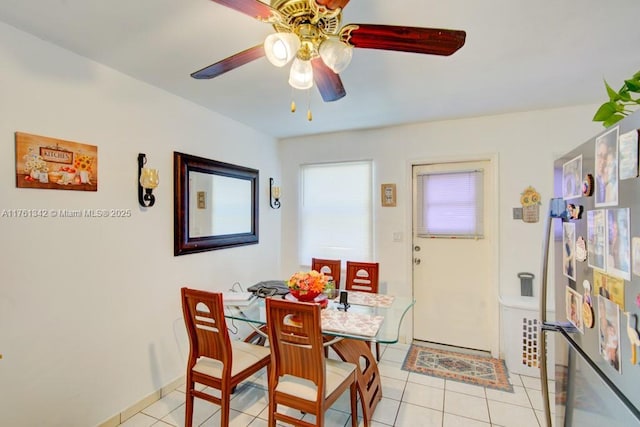 dining room with light tile patterned floors and a ceiling fan