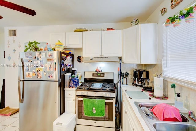 kitchen with visible vents, under cabinet range hood, white cabinetry, stainless steel appliances, and light countertops