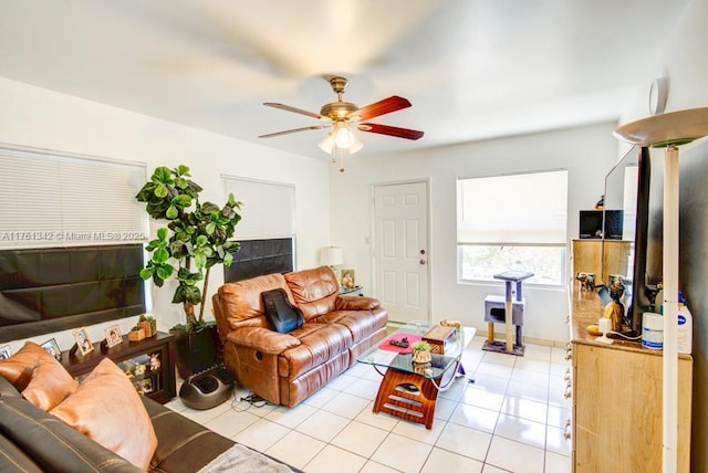 living area with light tile patterned floors and a ceiling fan