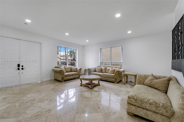 living area featuring recessed lighting, marble finish floor, and baseboards