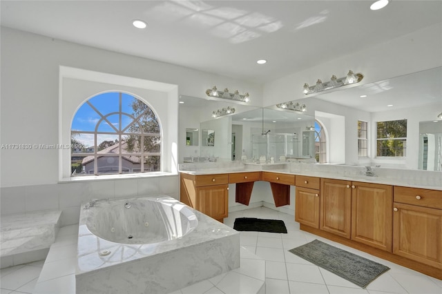 bathroom with vanity, tile patterned floors, recessed lighting, and a tub with jets