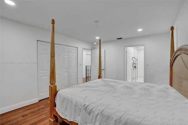 bedroom featuring recessed lighting, wood finished floors, visible vents, and baseboards