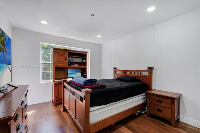 bedroom featuring recessed lighting, wood finished floors, and baseboards