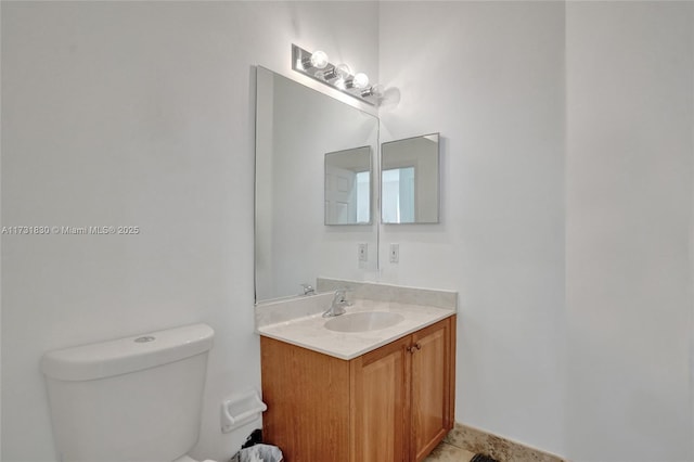 bathroom featuring toilet and vanity