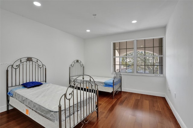 bedroom featuring recessed lighting, wood finished floors, and baseboards