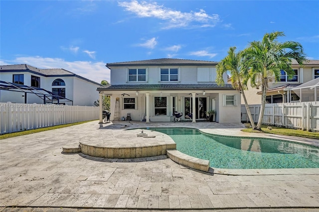 back of property featuring stucco siding, a patio, a fenced backyard, and a tile roof