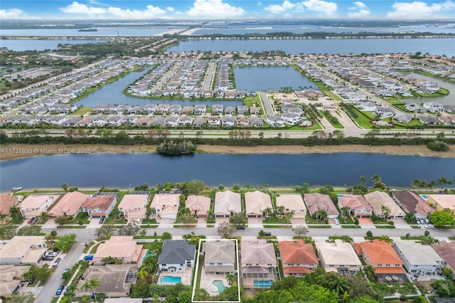 drone / aerial view with a residential view and a water view