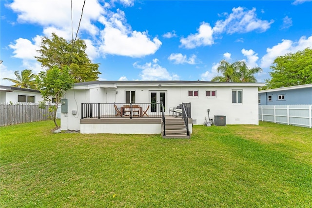 back of property featuring central air condition unit, a lawn, french doors, and a fenced backyard