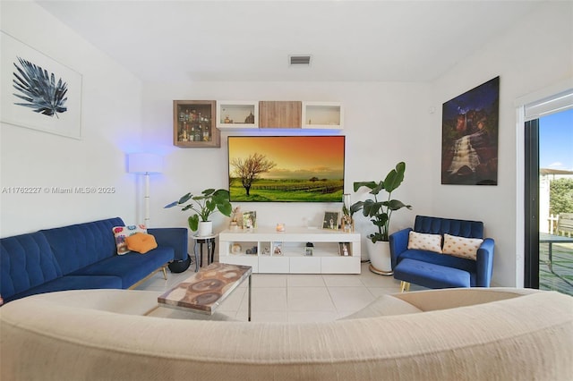 living area with tile patterned floors and visible vents