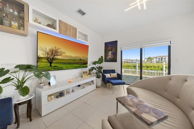 living room featuring visible vents and light tile patterned flooring