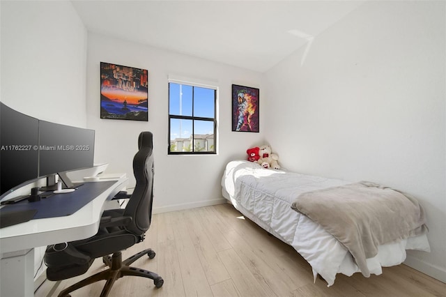 bedroom featuring wood finished floors and baseboards