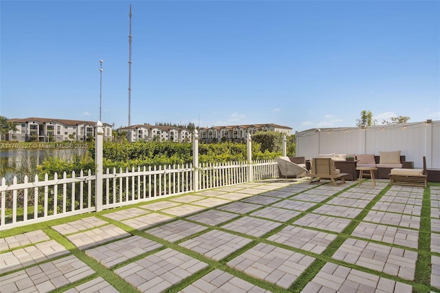 view of yard featuring an outdoor living space, fence, a residential view, and a patio area