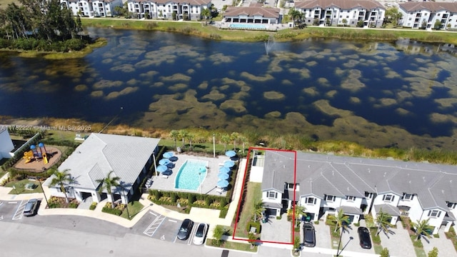 drone / aerial view featuring a residential view and a water view