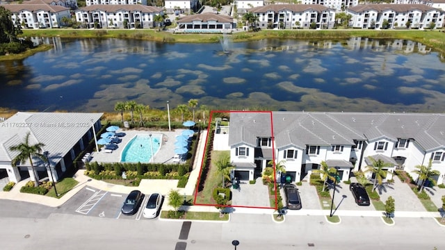 drone / aerial view featuring a residential view and a water view