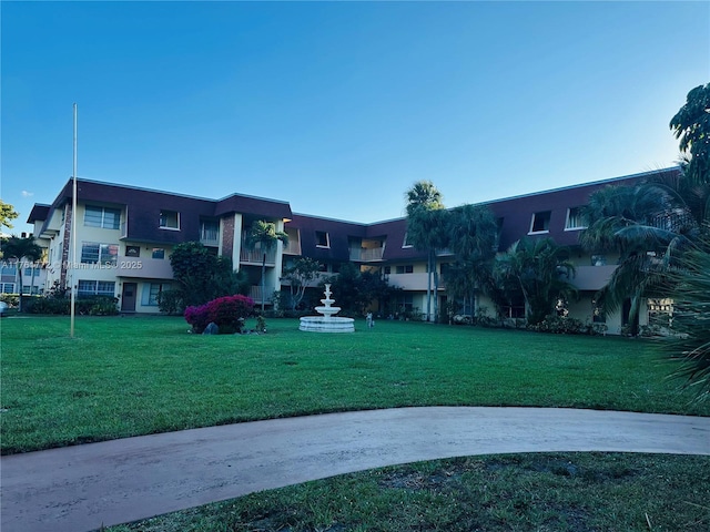 view of property's community with a lawn