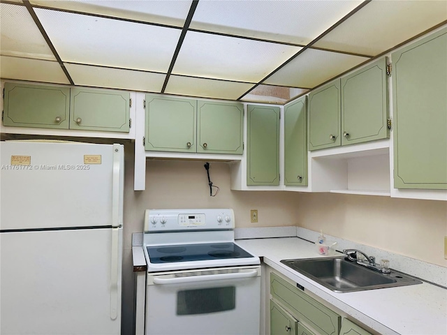 kitchen with open shelves, green cabinetry, light countertops, white appliances, and a sink