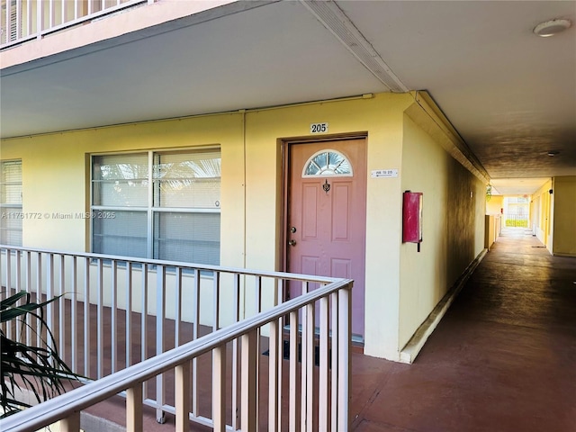 view of exterior entry featuring stucco siding