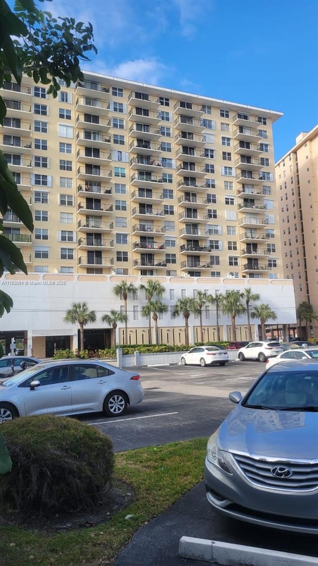 view of building exterior featuring uncovered parking