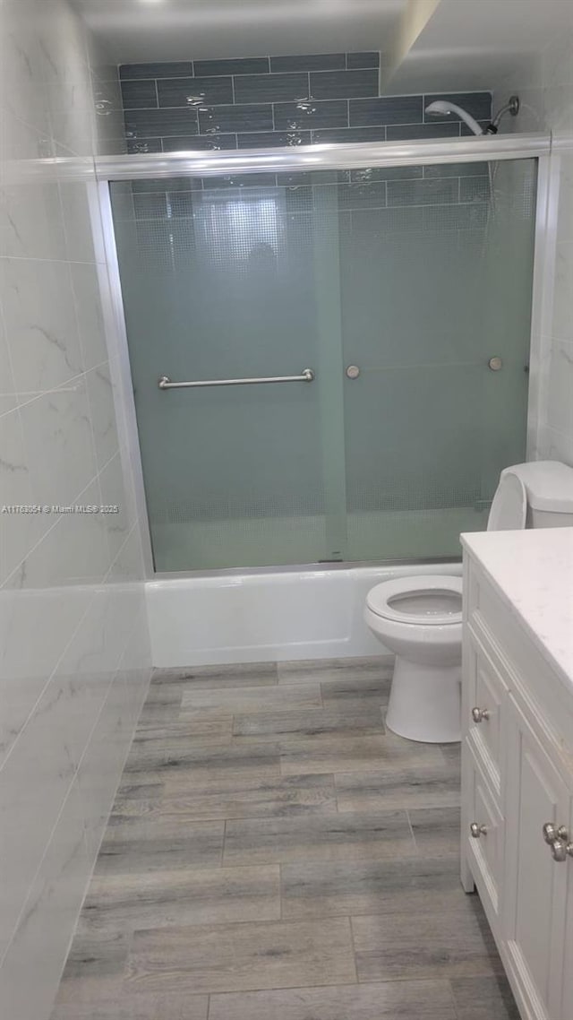 bathroom featuring vanity, toilet, and wood finished floors