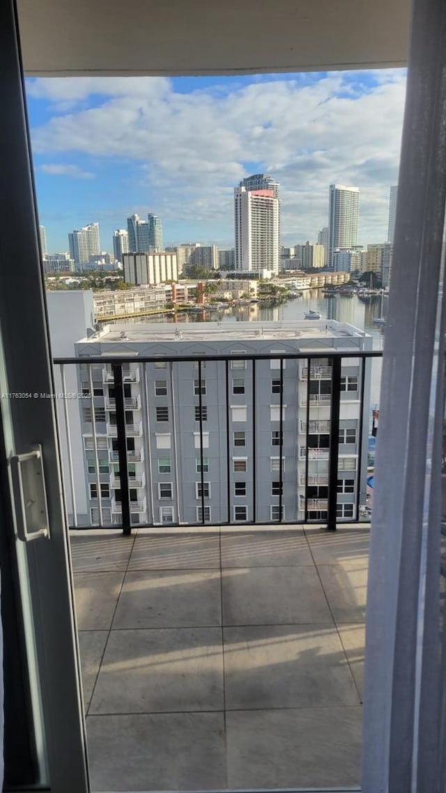 balcony featuring a view of city and a water view