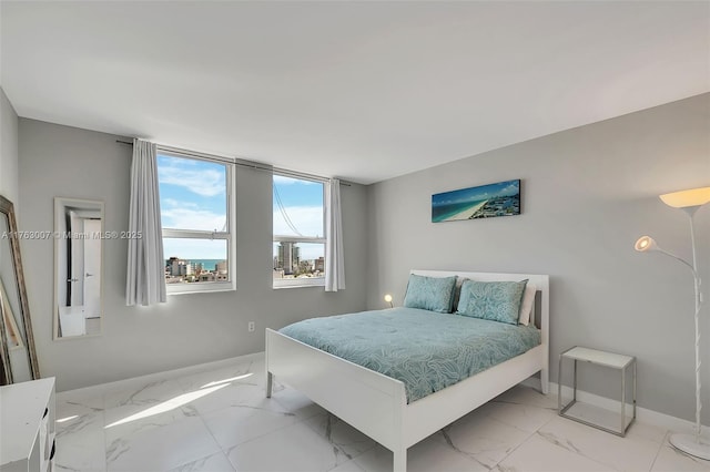 bedroom with marble finish floor and baseboards