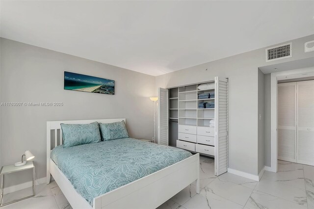 bedroom with visible vents, marble finish floor, and baseboards