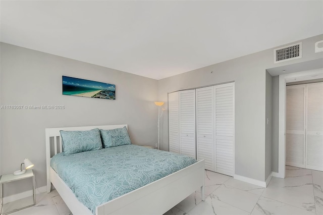 bedroom featuring visible vents, marble finish floor, and baseboards