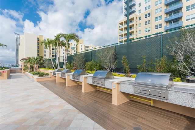 view of patio / terrace featuring area for grilling, fence, and an outdoor kitchen