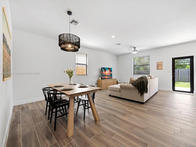 dining room with visible vents, plenty of natural light, and wood finished floors