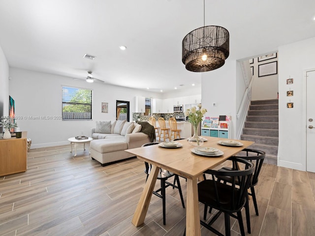 dining room featuring stairway, baseboards, visible vents, light wood finished floors, and recessed lighting