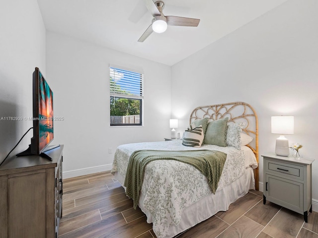 bedroom with wood finish floors, baseboards, and a ceiling fan