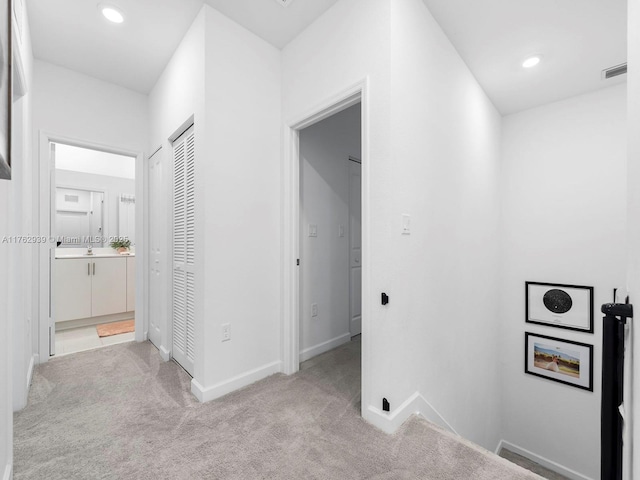 hallway featuring recessed lighting, visible vents, carpet floors, and baseboards