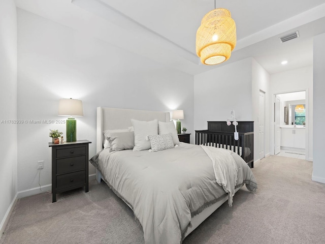 carpeted bedroom with visible vents, recessed lighting, ensuite bath, and baseboards