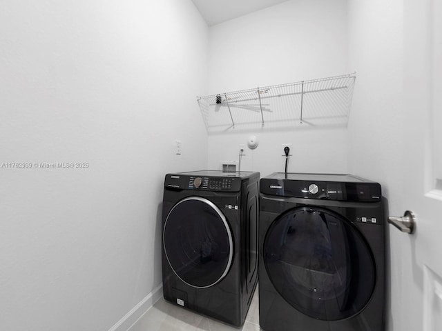 laundry area featuring laundry area, separate washer and dryer, and baseboards