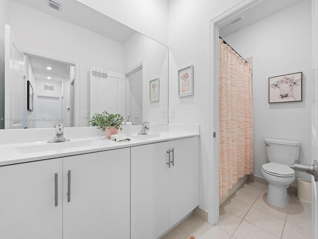 bathroom with a sink, visible vents, double vanity, and tile patterned flooring