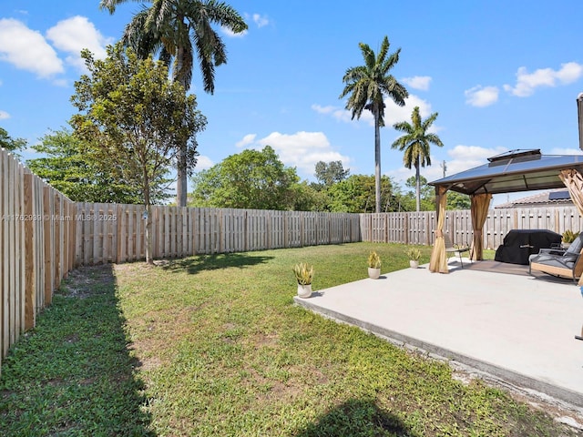 view of yard featuring a fenced backyard, a gazebo, and a patio