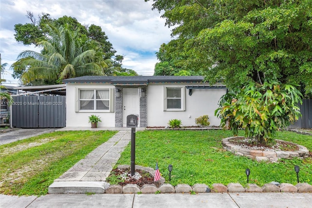 ranch-style house with stucco siding, a front lawn, and fence