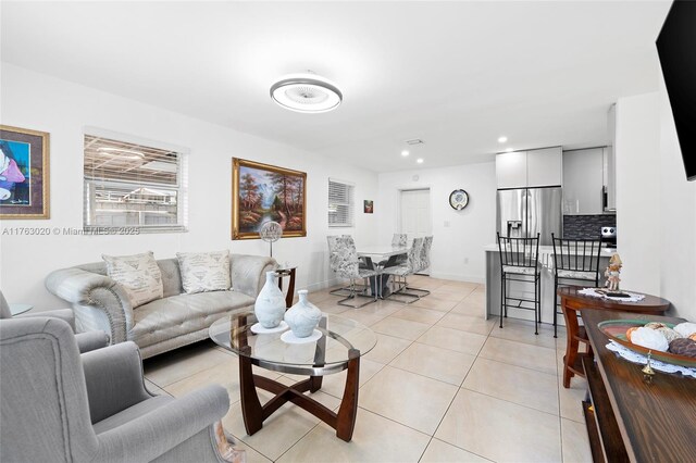 living area with light tile patterned flooring, recessed lighting, and baseboards