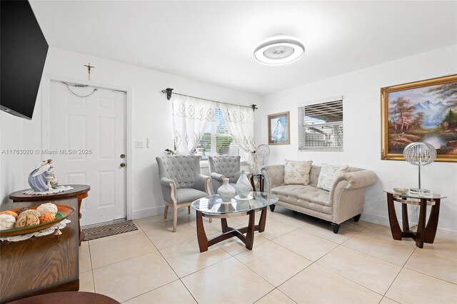 living room featuring light tile patterned floors and baseboards