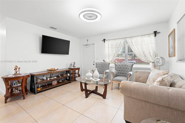 living room with light tile patterned floors and visible vents