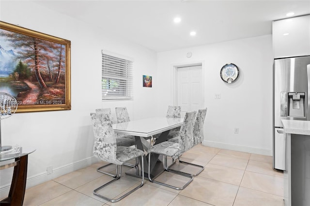 dining room with light tile patterned floors, recessed lighting, and baseboards