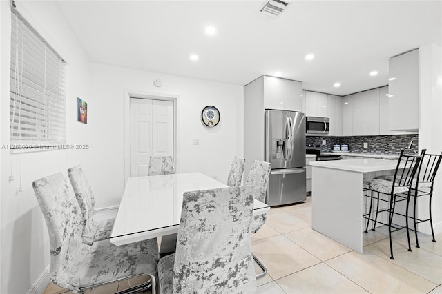 dining space featuring light tile patterned floors, visible vents, and recessed lighting