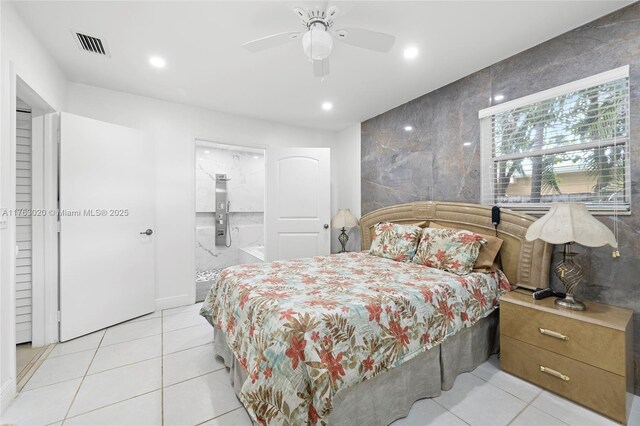 bedroom featuring light tile patterned floors, visible vents, ensuite bath, recessed lighting, and tile walls