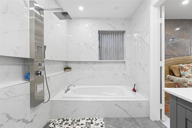 full bath featuring a marble finish shower, vanity, a garden tub, recessed lighting, and stone wall