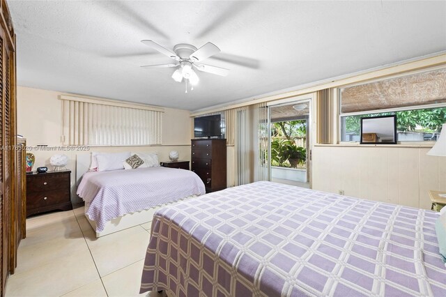 tiled bedroom with a ceiling fan