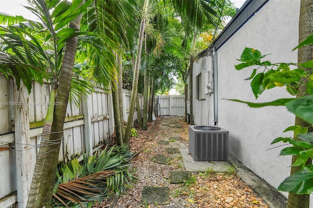 view of yard with central air condition unit and a fenced backyard